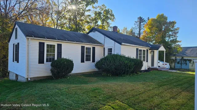 a view of a house with a yard and porch