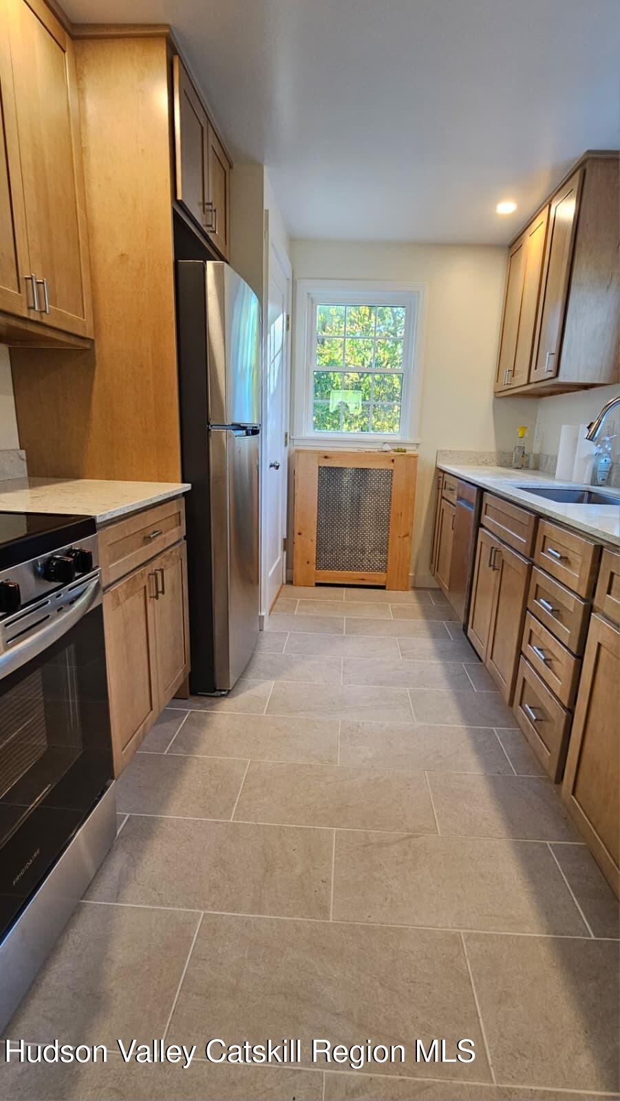 10370 Highway 22 Hillsdale, NY 12529 - Photo 2 of 7 a kitchen with stainless steel appliances a refrigerator sink and cabinets