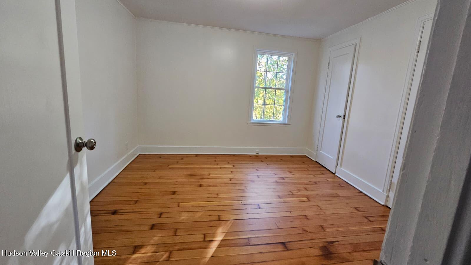 10370 Highway 22 Hillsdale, NY 12529 - Photo 6 of 7 an empty room with wooden floor and windows