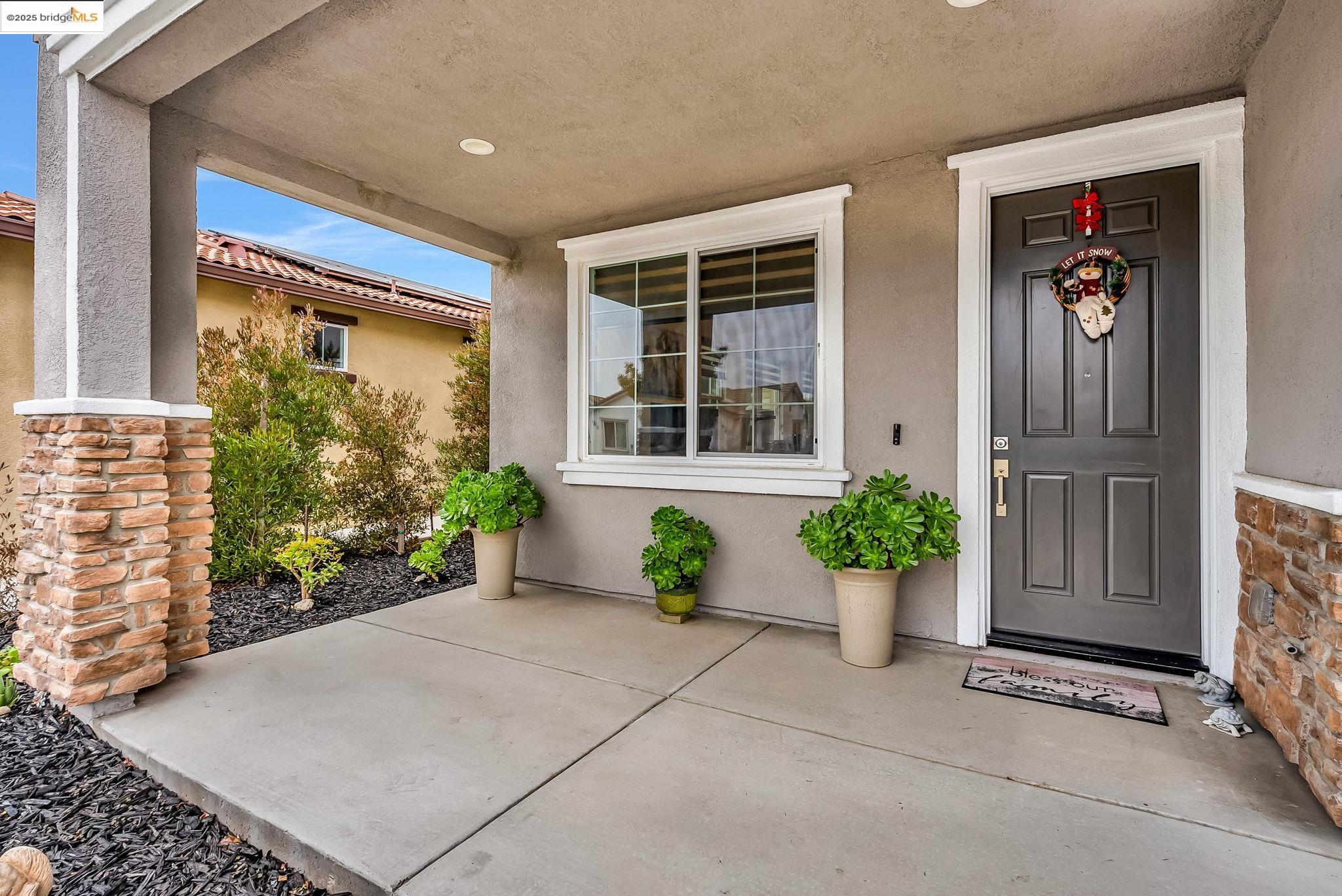 front view of a house with potted plants