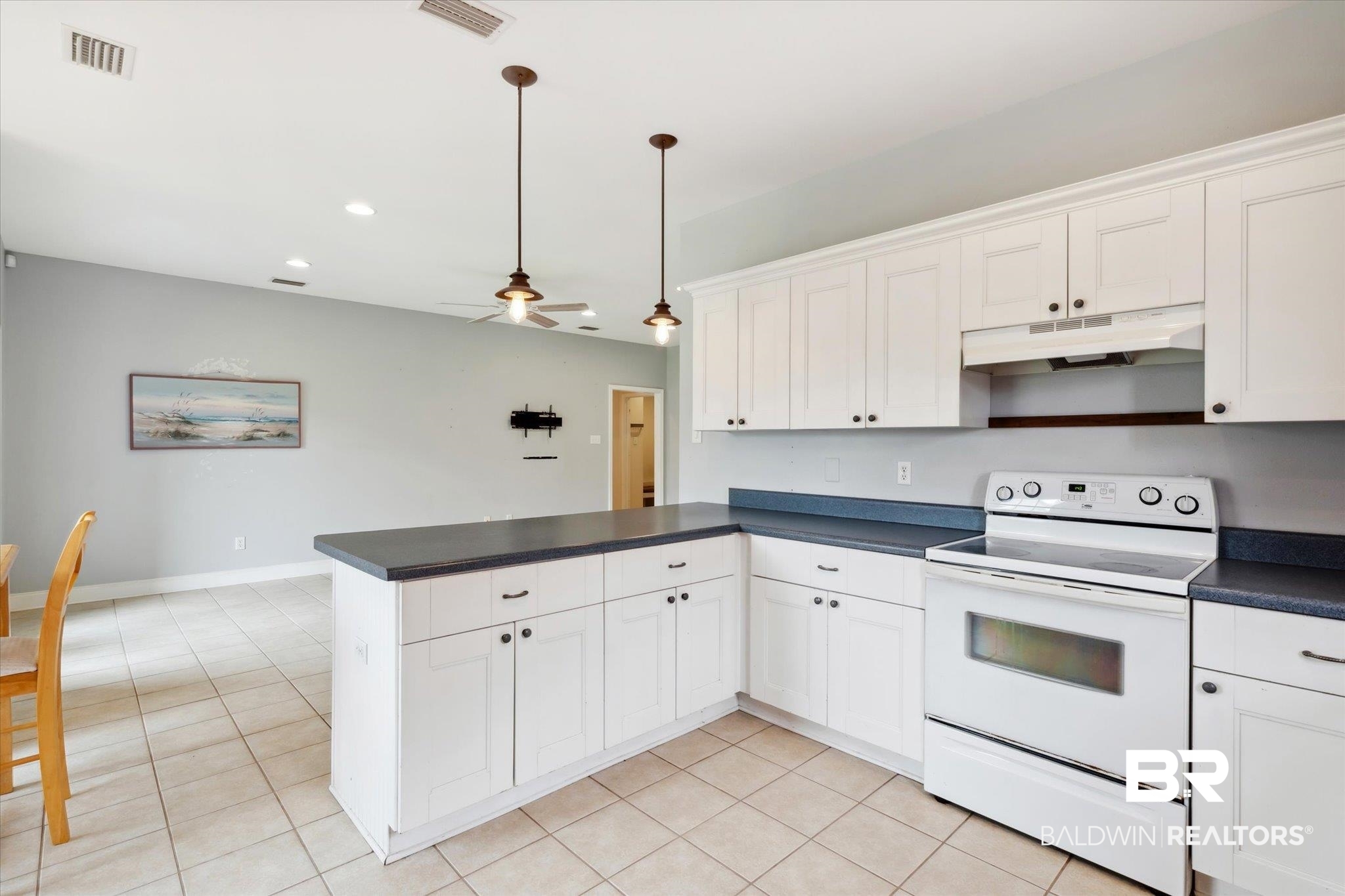 17297 Tallasee Boulevard Foley, AL 36535 - Photo 8 of 24 Kitchen featuring light tile patterned floors, electric stove, ceiling fan, white cabinets, and kitchen peninsula