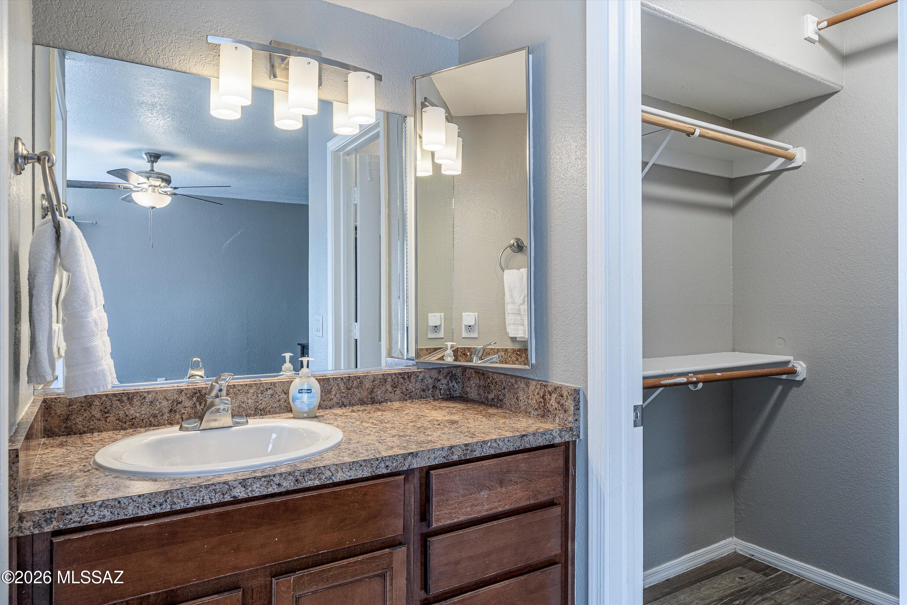 5855 North Kolb Road, Unit 8106 Tucson, AZ 85750 - Photo 21 of 34 a bathroom with a granite countertop sink and a mirror