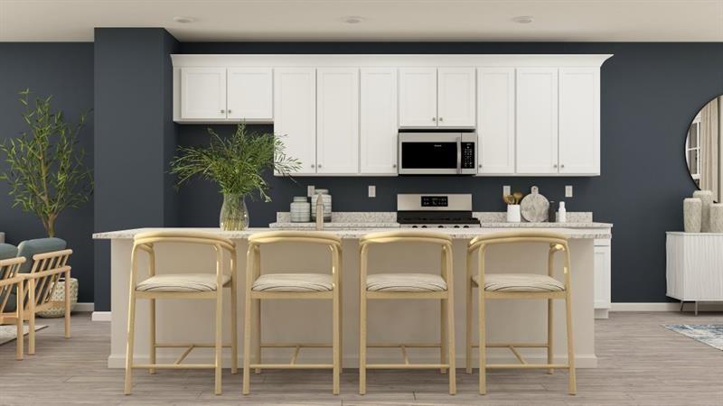 59 Constitution Avenue Pendergrass, GA 30567 - Photo 8 of 27 a white kitchen with stainless steel appliances granite countertop a white cabinets and a stove top oven