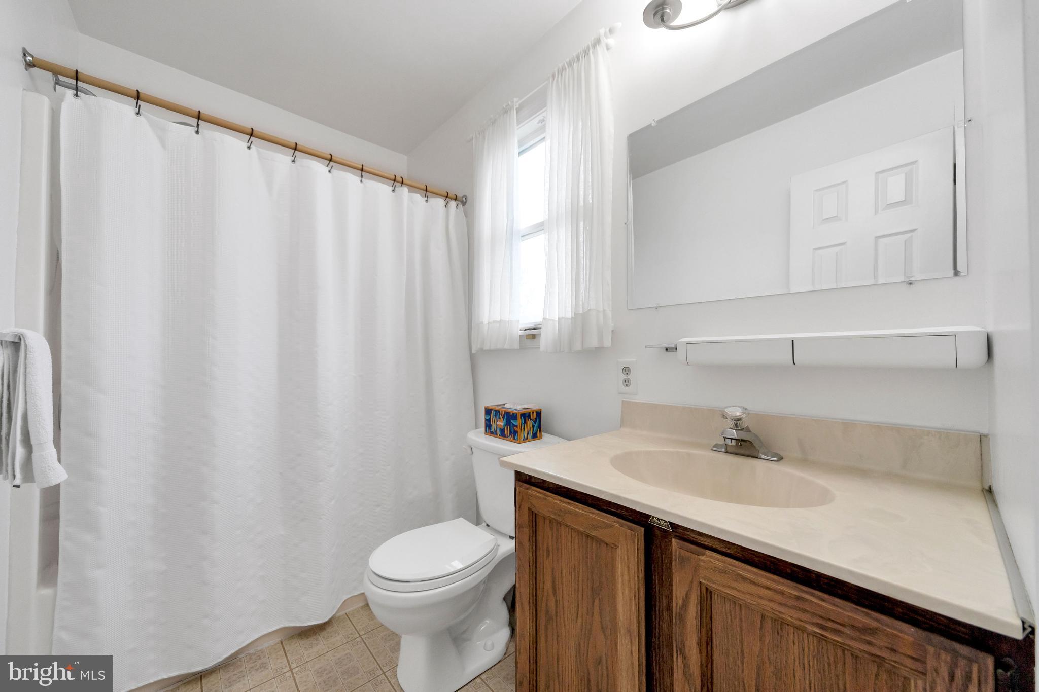1072 Independence Way Hatfield, PA 19440 - Photo 32 of 37 a bathroom with a sink a toilet and shower curtain