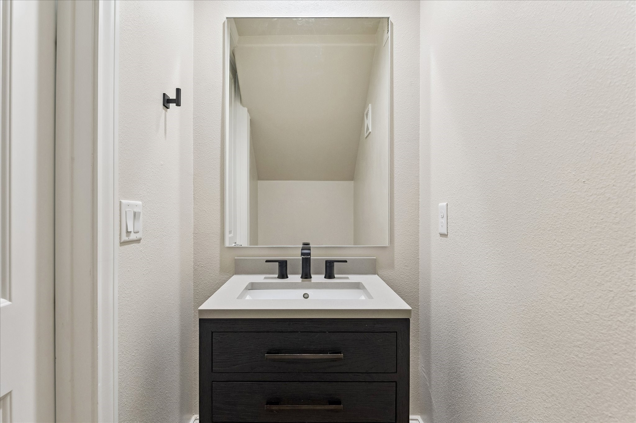 6108 Nicholas Grove Place Houston, TX 77055 - Photo 8 of 29 The seller upgraded to a Restoration Hardware vanity sink in the half-bath, tucked discreetly under the stairwell.