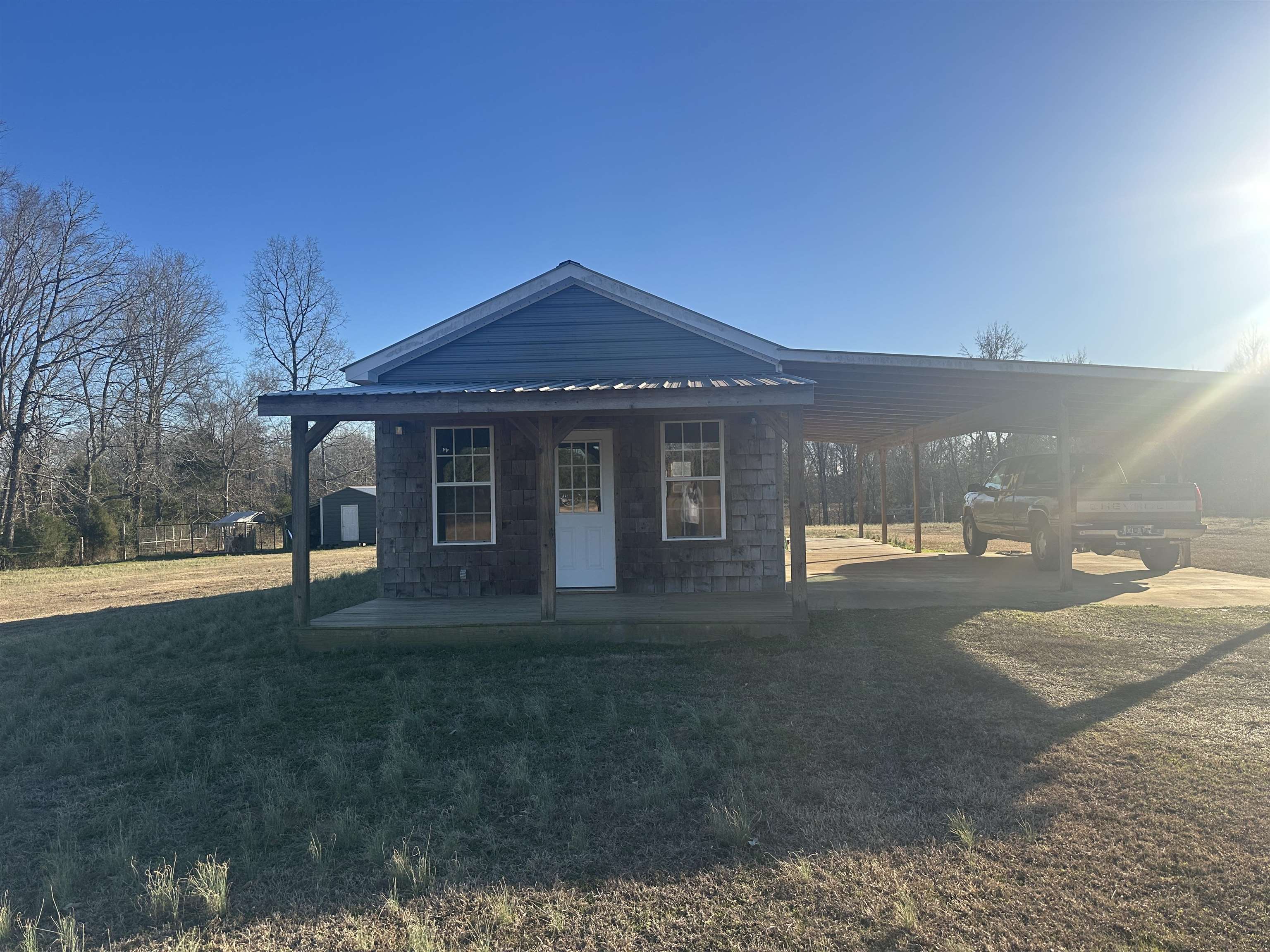 2245 Fritton Spur Road Middleton, TN 38052 - Photo 2 of 24 View of front of property featuring a carport, covered porch, and a front yard