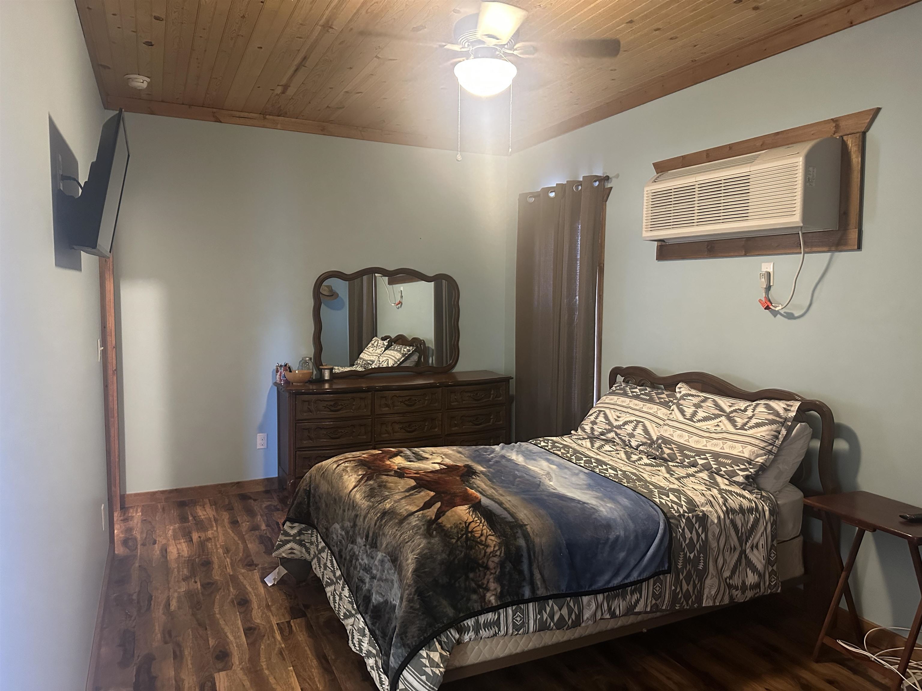 2245 Fritton Spur Road Middleton, TN 38052 - Photo 21 of 24 Bedroom featuring wood ceiling, dark wood-style flooring, a wall unit AC, and ceiling fan