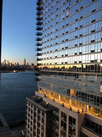 a terrace with outdoor seating and city view