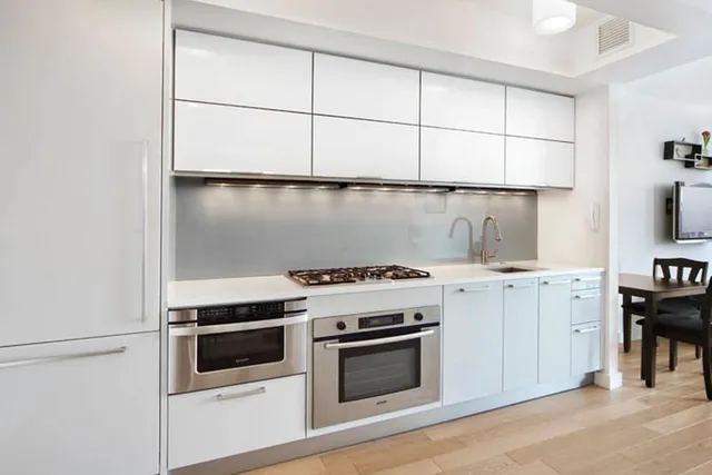 a white stove top oven sitting inside of a kitchen