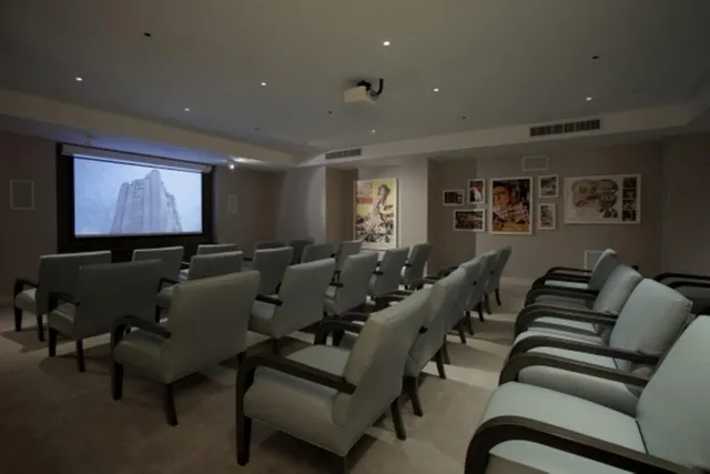 a media room with lots of chairs and a projector