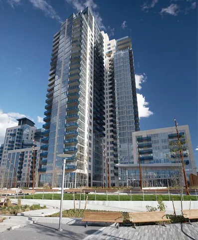 a view of a tall building next to a yard