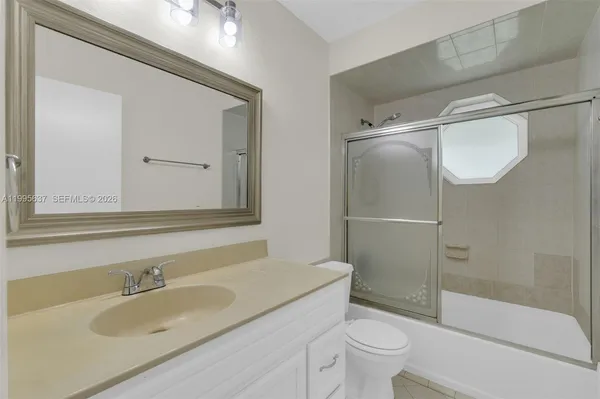 a bathroom with a shower a toilet and sink