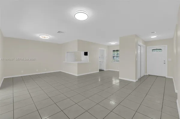 a view of a kitchen with white cabinets
