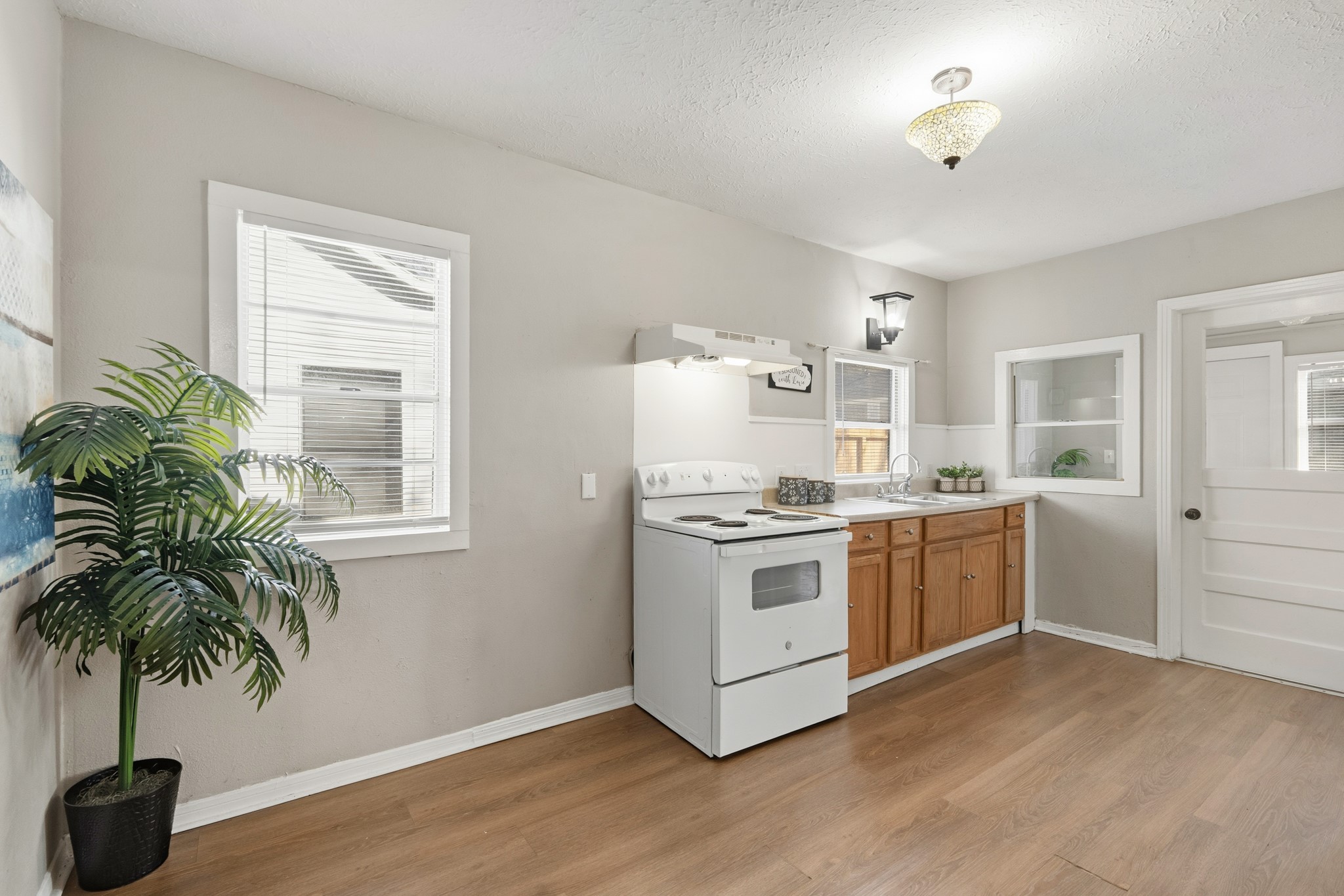 1509 Mulcahy Street Rosenberg, TX 77471 - Photo 11 of 41 a kitchen with a white stove top oven and potted plant