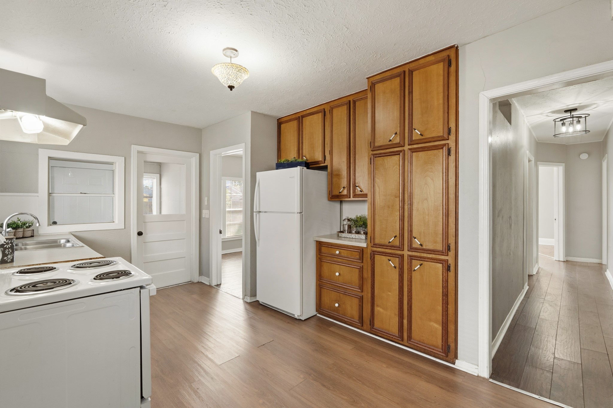 1509 Mulcahy Street Rosenberg, TX 77471 - Photo 13 of 41 a kitchen with white cabinets and refrigerator