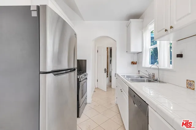 a spacious bathroom with a double vanity sink and a mirror