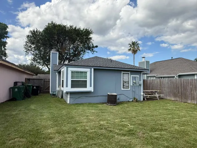 a front view of a house with a garden and plants