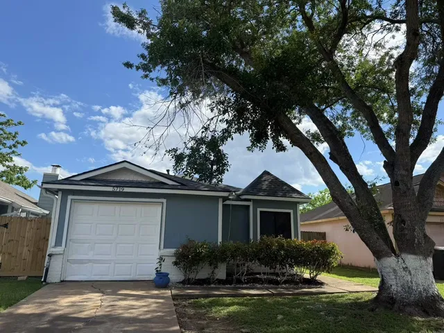 a front view of a house with a yard garage and outdoor seating