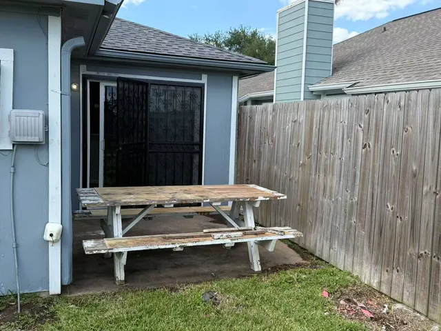 a view of a backyard with a table and chairs