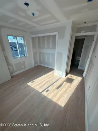 a view of wooden floor and windows in a room