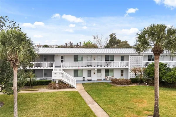 a front view of a house with a yard table and chairs