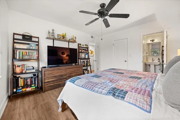a bedroom with furniture and a flat screen tv