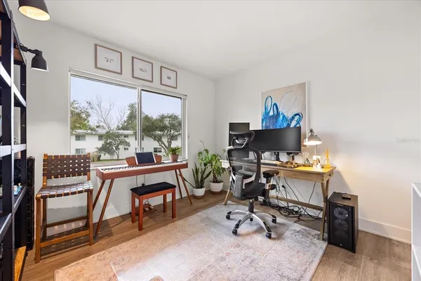 a view of a workspace with furniture and a window