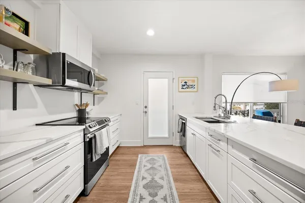 a kitchen with stainless steel appliances a sink and a stove