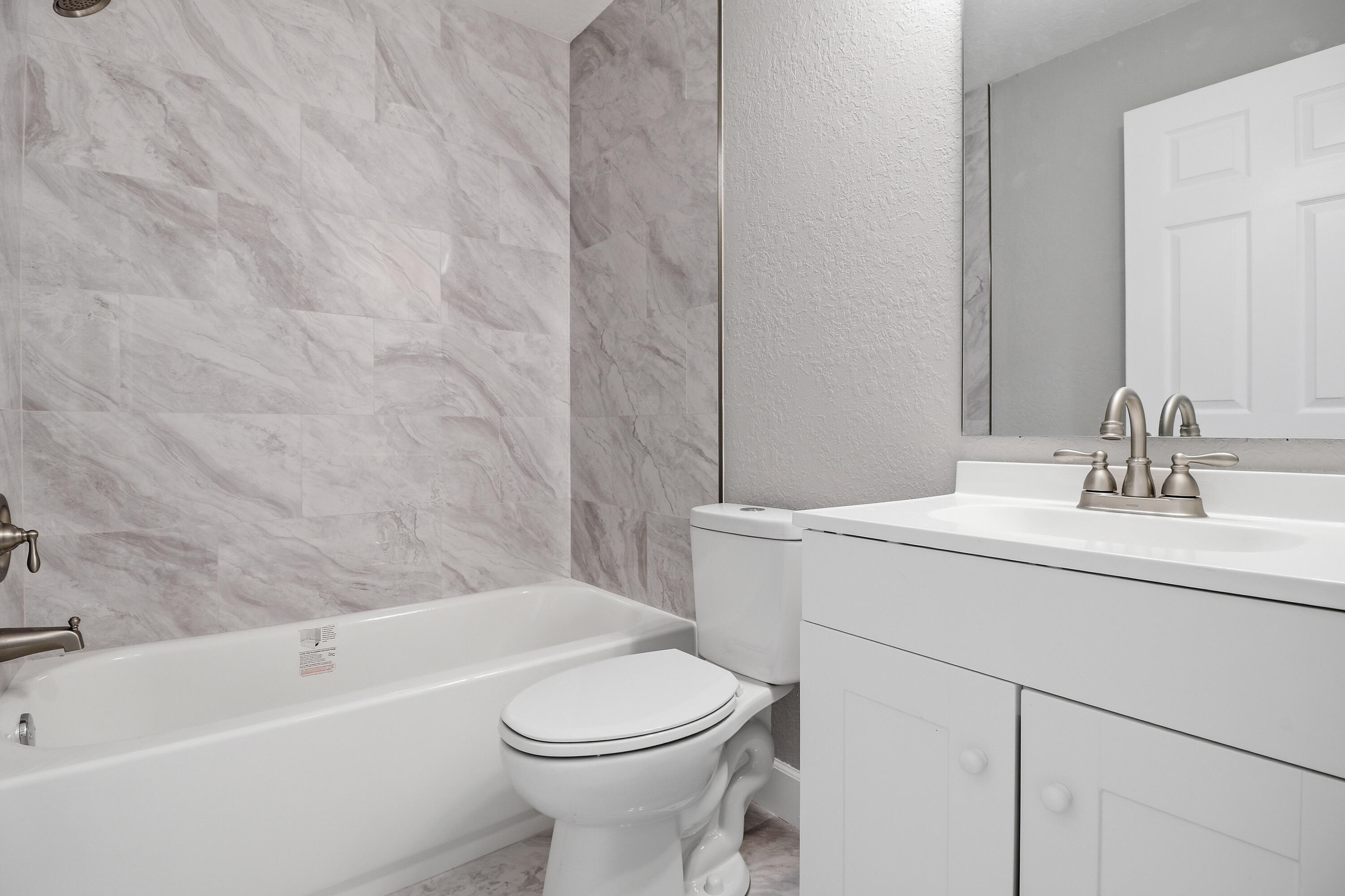 2805 Southeast Carroll Street Stuart, FL 34997 - Photo 12 of 21 a bathroom with a sink a toilet and shower