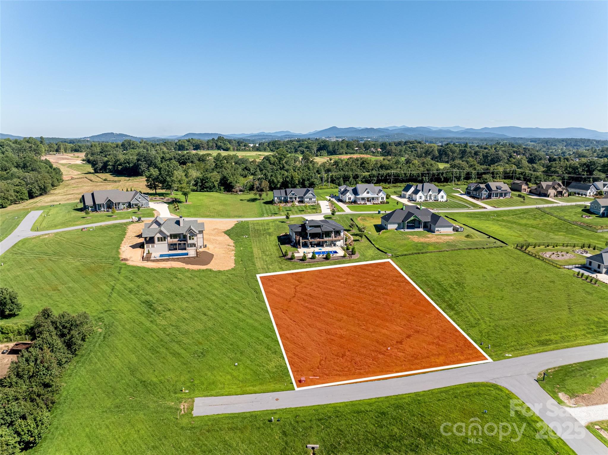 an aerial view of a golf course with parking space