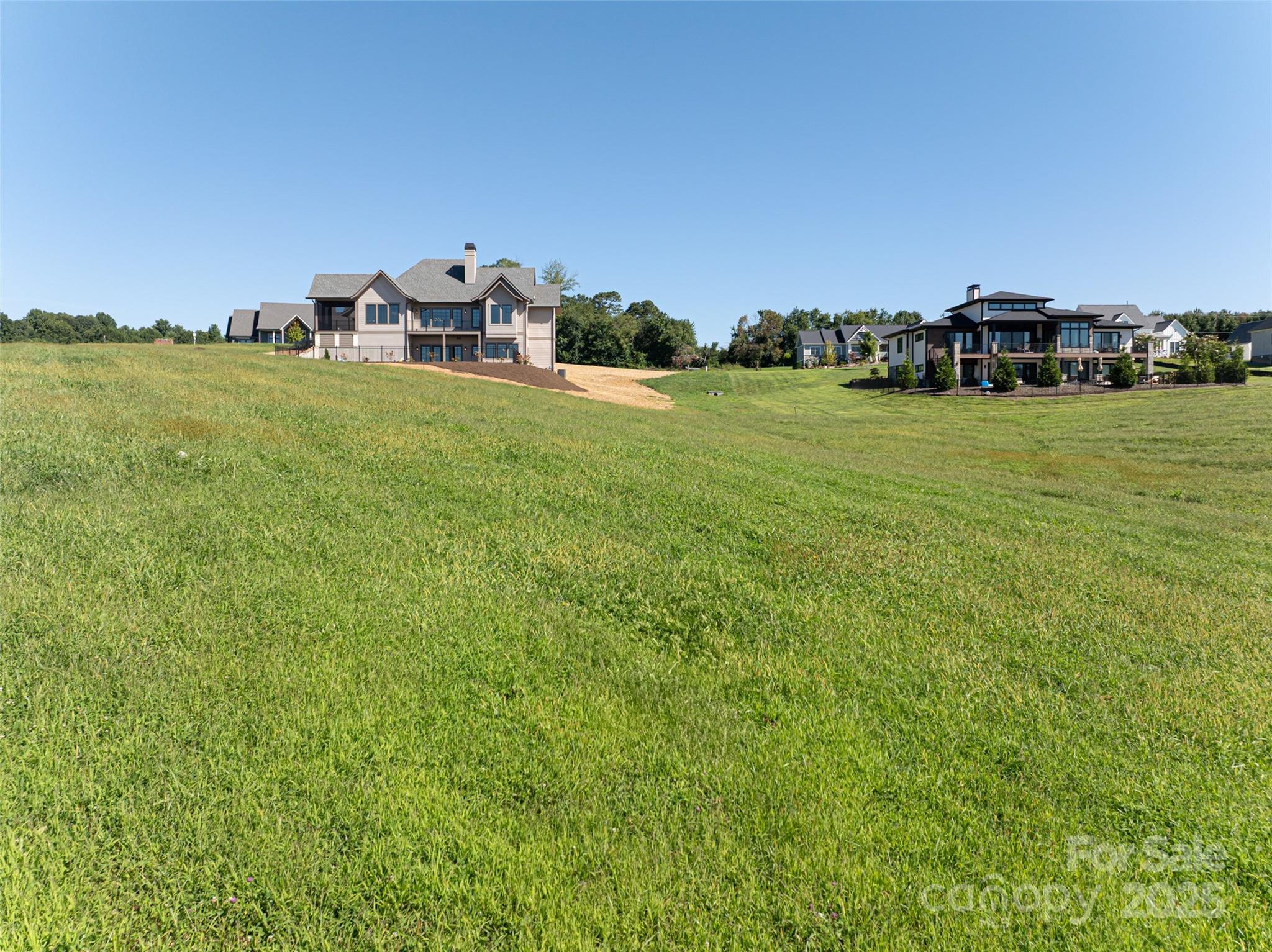 108 Double Knob Road, Unit 65 Mills River, NC 28759 - Photo 4 of 9 a view of a lake with houses with outdoor space