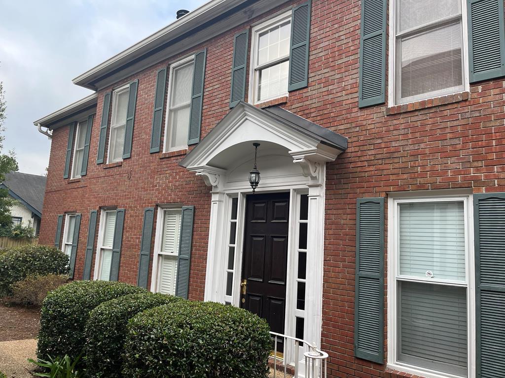 a front view of a house with a garden
