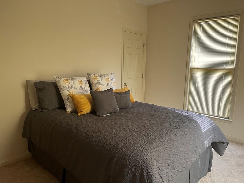 2250 15th Street, Unit 7 Columbus, GA 31906 - Photo 10 of 14 a bed sitting in a bedroom next to a window