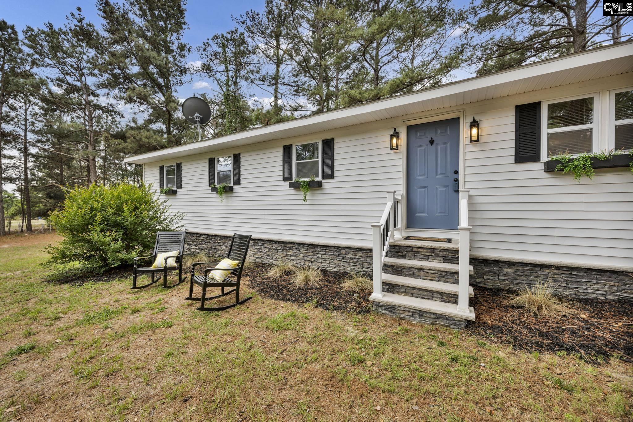 8107 Black River Road Rembert, SC 29128 - Photo 2 of 38 a view of a house with backyard and sitting area