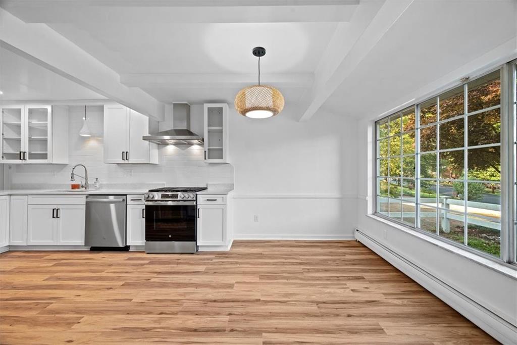 233 Sunset Drive Pittsburgh, PA 15235 - Photo 13 of 48 a kitchen with stainless steel appliances granite countertop a wooden cabinets a stove a sink and a wooden floors
