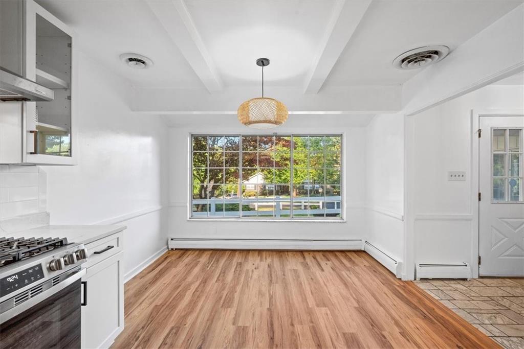 233 Sunset Drive Pittsburgh, PA 15235 - Photo 14 of 48 a kitchen with wooden floors a sink and a window