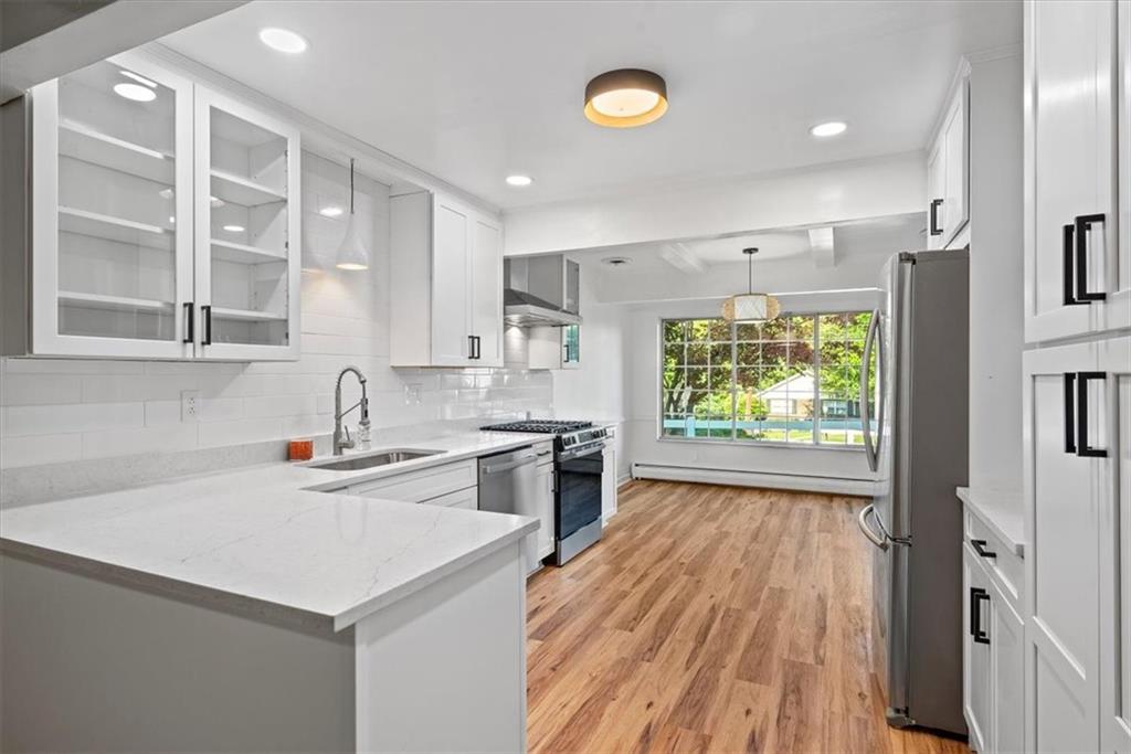 233 Sunset Drive Pittsburgh, PA 15235 - Photo 16 of 48 a kitchen with a sink stove and cabinets