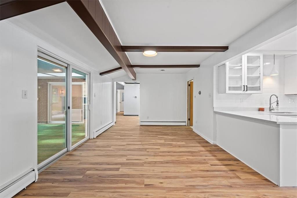 233 Sunset Drive Pittsburgh, PA 15235 - Photo 21 of 48 a view of an empty room with wooden floor and a window