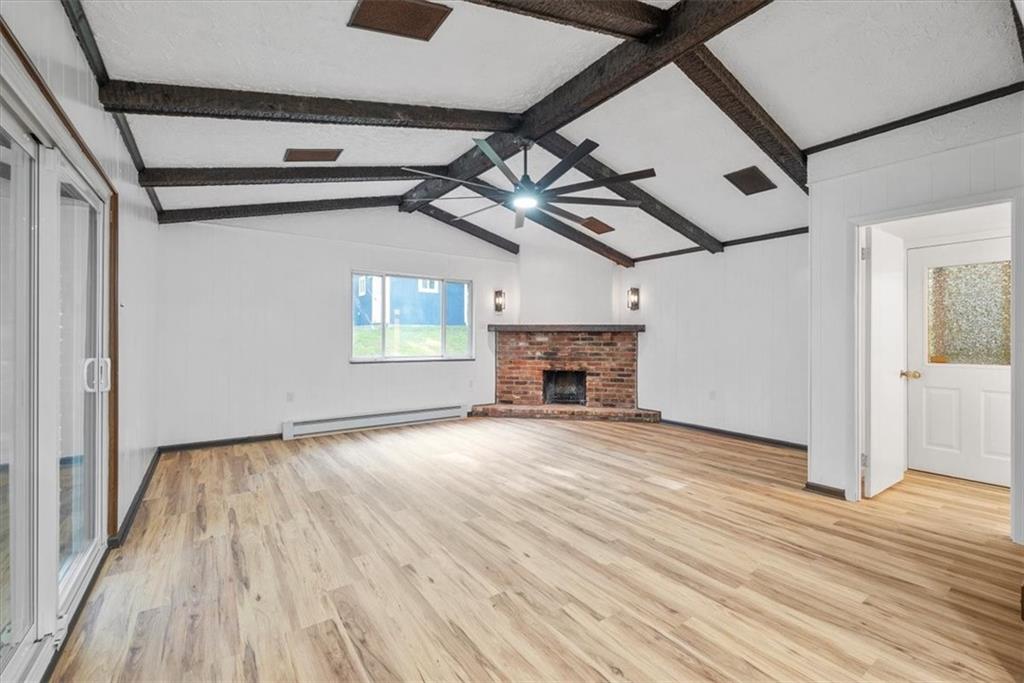 233 Sunset Drive Pittsburgh, PA 15235 - Photo 22 of 48 a view of empty room with wooden floor and fireplace