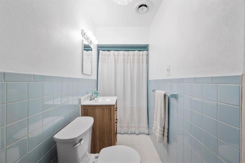 233 Sunset Drive Pittsburgh, PA 15235 - Photo 26 of 48 a white toilet sitting next to a bathroom sink and a shower