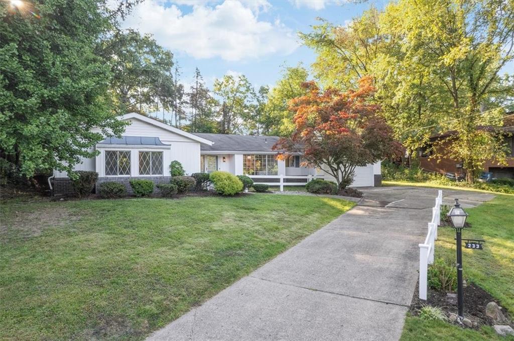233 Sunset Drive Pittsburgh, PA 15235 - Photo 3 of 48 a front view of a house with a yard and trees