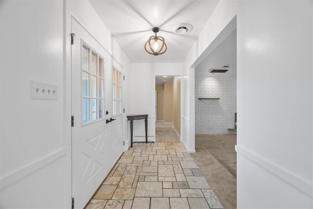 233 Sunset Drive Pittsburgh, PA 15235 - Photo 6 of 48 a very nice looking hallway with a chandelier