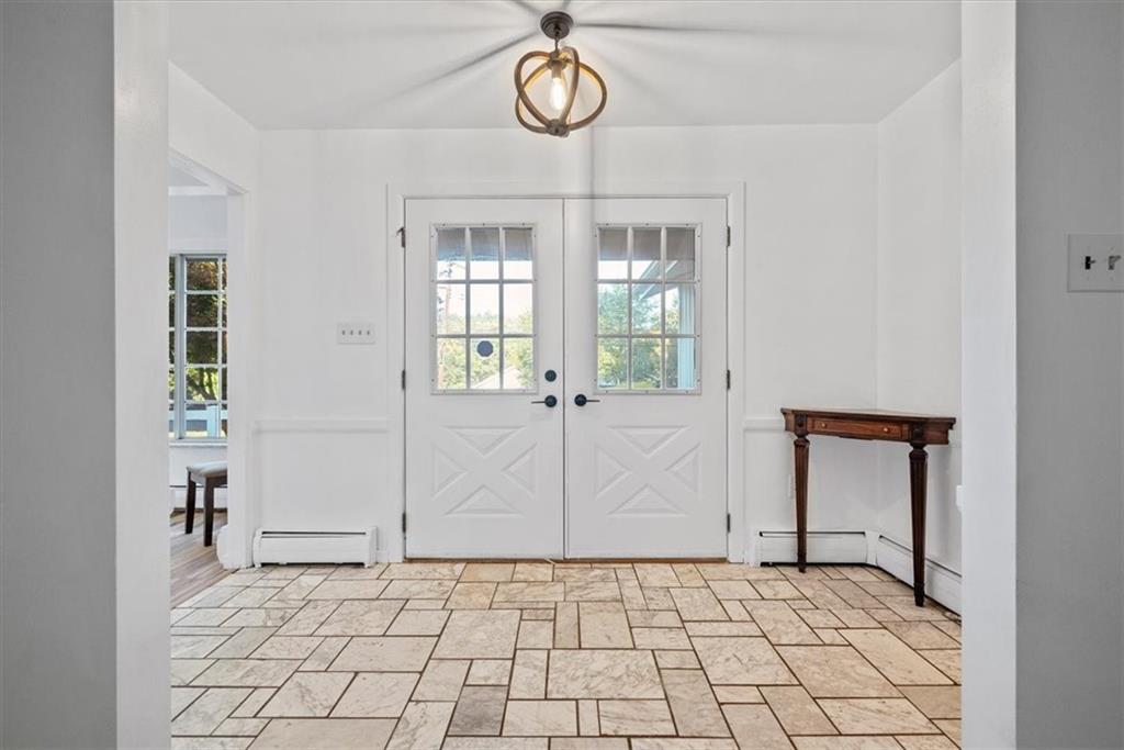 233 Sunset Drive Pittsburgh, PA 15235 - Photo 8 of 48 a view of an empty room with wooden floor and a window