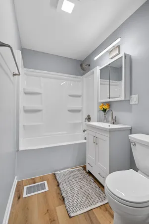 a bathroom with a toilet a sink and bathtub