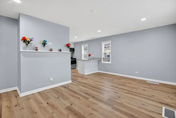 a view of a kitchen with wooden floor and cabinet