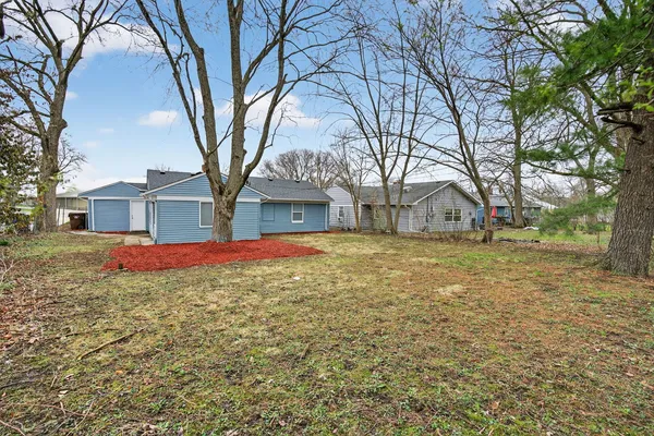 a view of house with yard