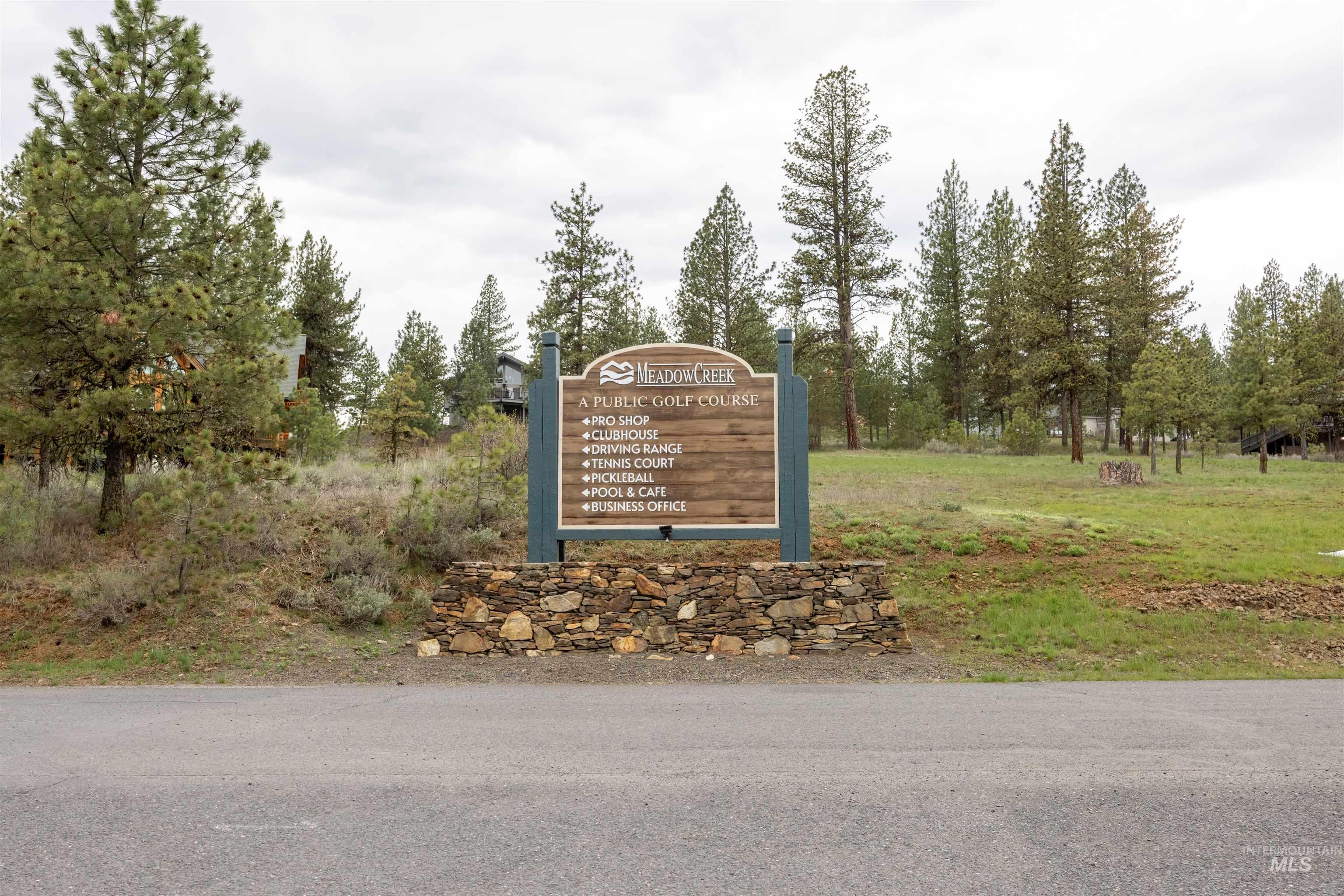 3873 Hot Springs Road New Meadows, ID 83654 - Photo 19 of 25 Meadow Creek entry sign features a stone base and wood-finish paneling