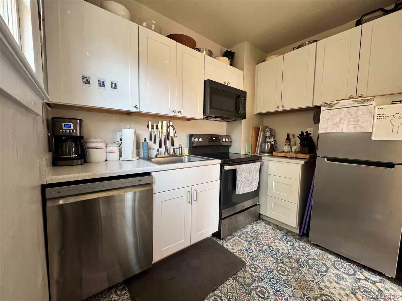 966 Garfield Street Denver, CO 80206 - Photo 12 of 27 a kitchen with white cabinets and white appliances