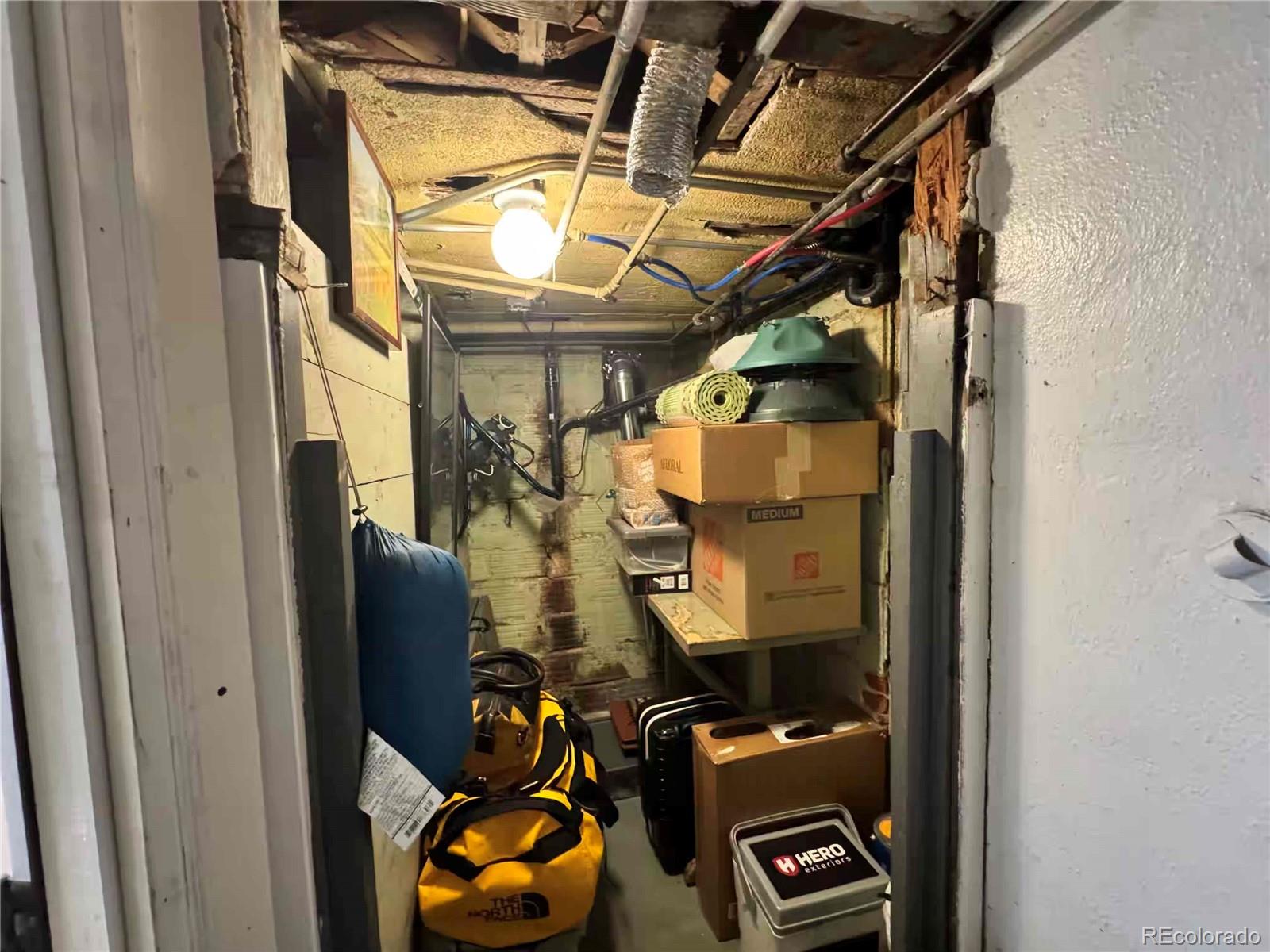 966 Garfield Street Denver, CO 80206 - Photo 16 of 27 a view of walk in closet with clothes and shoes