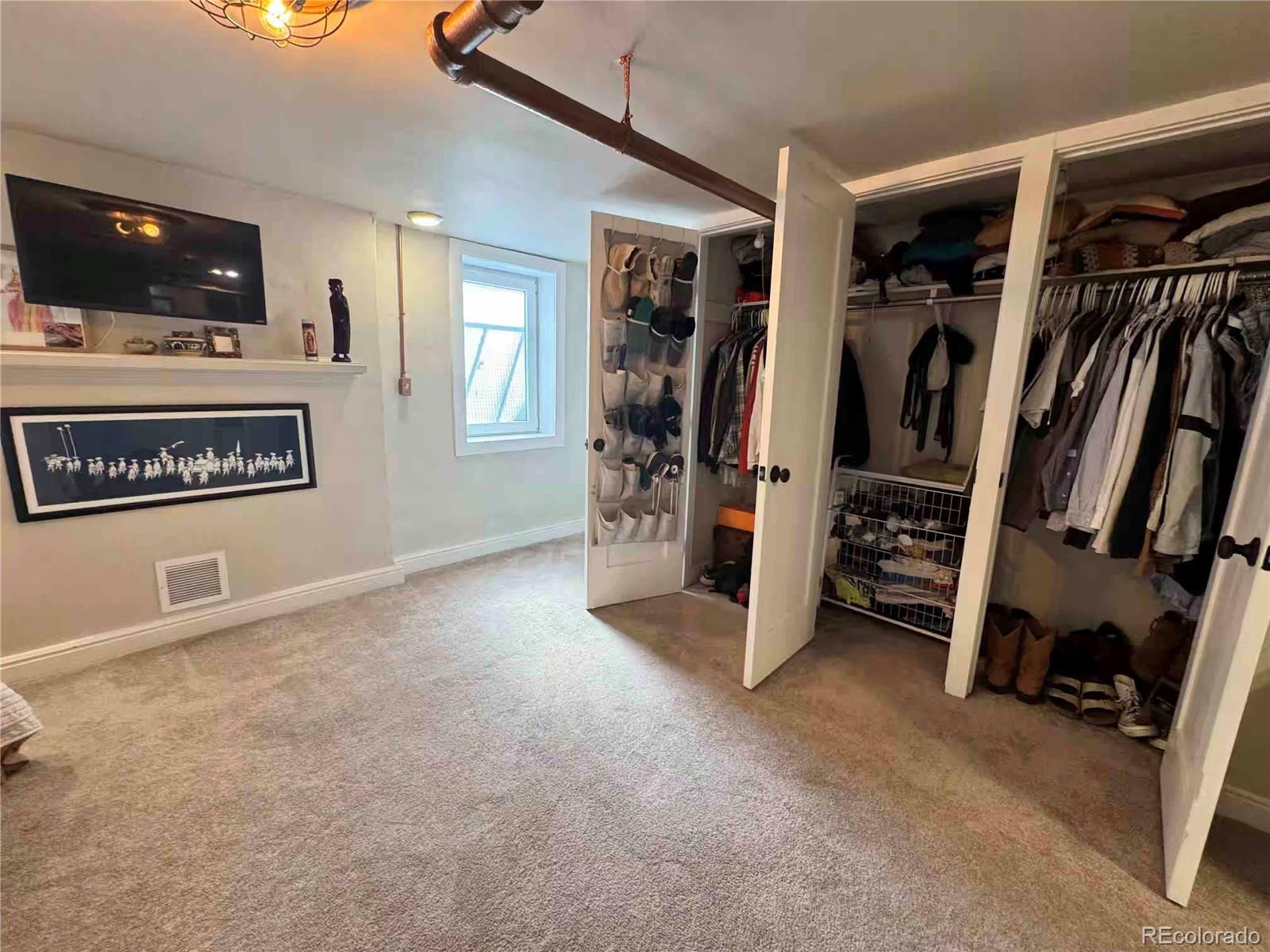 966 Garfield Street Denver, CO 80206 - Photo 20 of 27 a view of a livingroom with furniture and a flat screen tv